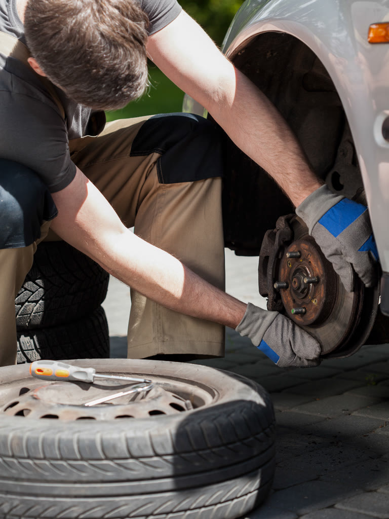 Technician servicing a brake assembly