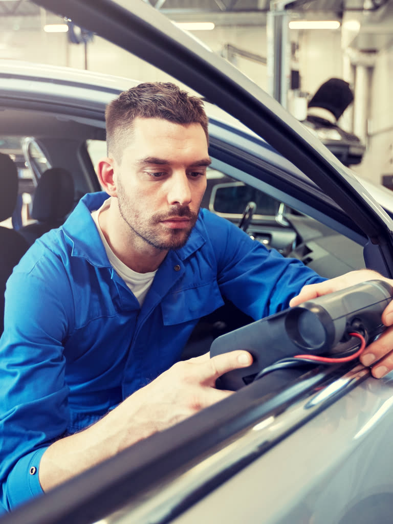 Technician using a scan tool at the dashboard port