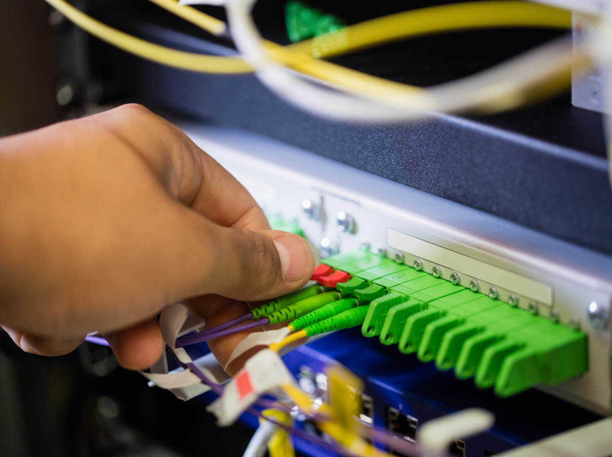 Low-voltage technician terminating fiber optic cables
