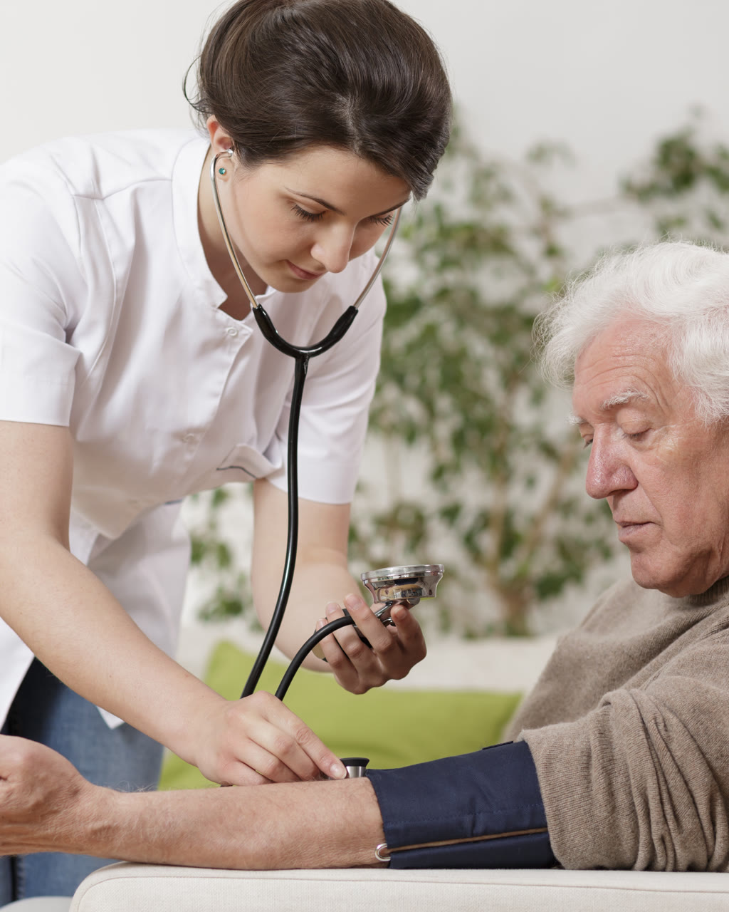 Medical assistant taking a patient's blood pressure